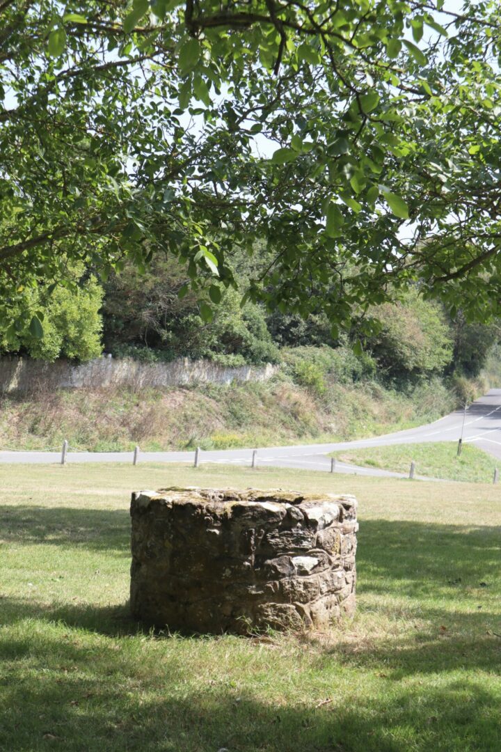 A stone structure in the middle of a field.